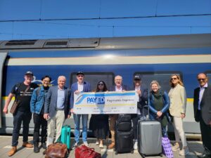 Money 20/20 Europe 2023 1 The PayEd Payments Express attendees stood in front of the train on the platform before boarding.