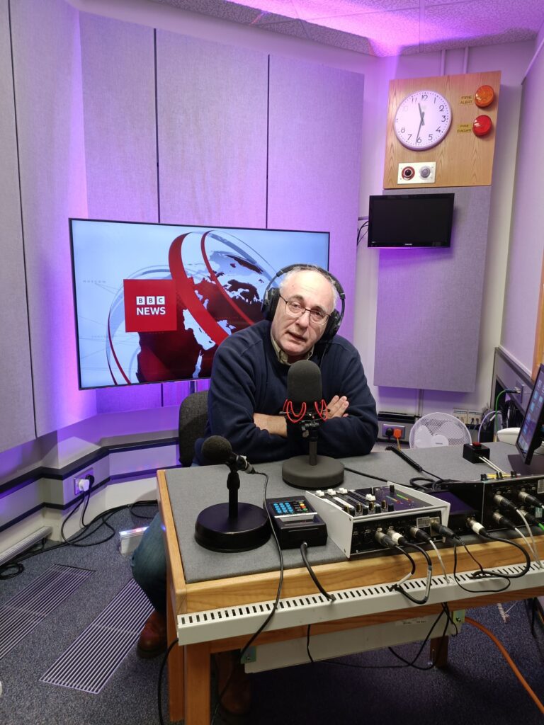 In the studio...- David Birch sat at mic at a sound desk