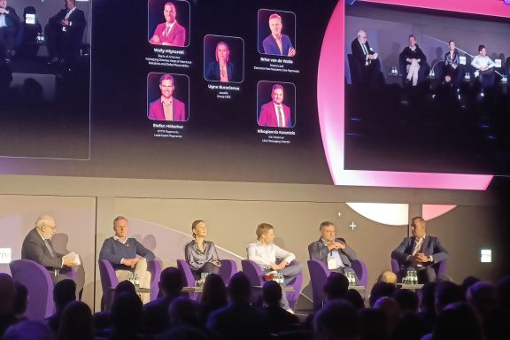 Moderating: The Big Talk. Image of 5 panellists on stage with David Birch in the first panel session of Merchant Payments Ecosystem 2025